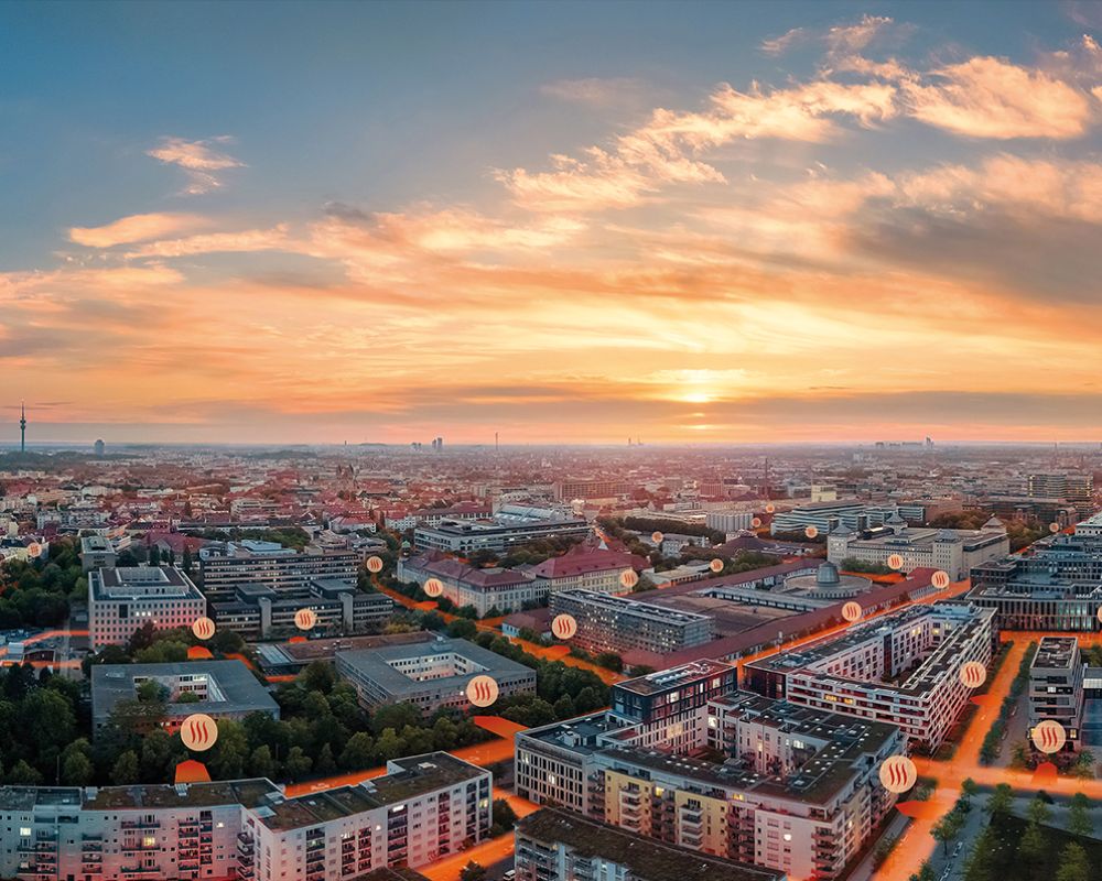 Luftaufnahme von München mit visualisiertem Fernwärmenetz